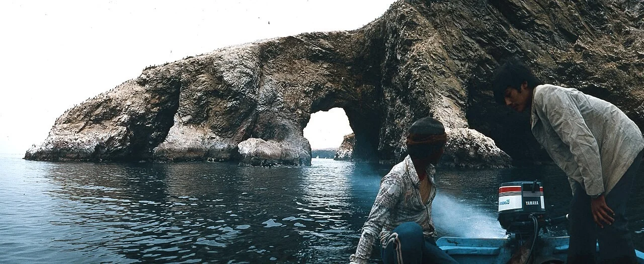 Rock arch and a small boat at the Ballestas Islands