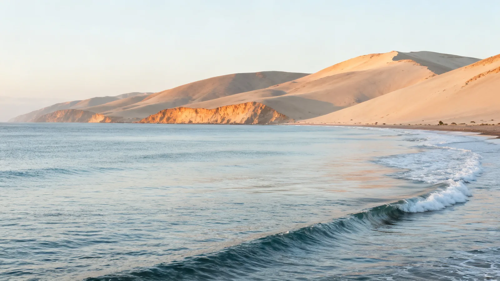 Photographic illustration of a quiet Pacific bay and pale desert hills